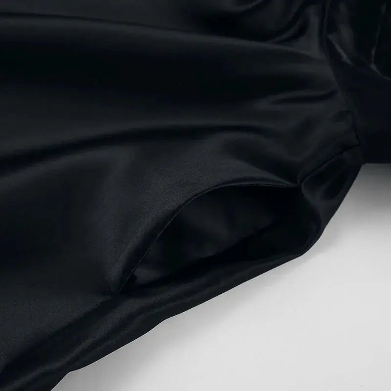 Black backless halter mini dress for women by Jungle Line, sleeveless French style short dress with pockets, ideal for evening parties.
