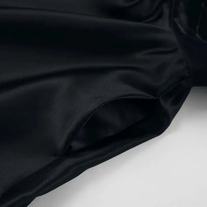 Black backless halter mini dress for women by Jungle Line, sleeveless French style short dress with pockets, ideal for evening parties.