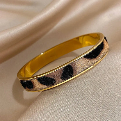 Gold-colored Leopard Print Welt Women's Bracelet by Jungle Line featuring a stylish leopard pattern and woven design.