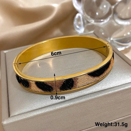 Gold-colored Greatera Leopard Print Welt Women's Bracelet by Jungle Line with stylish leopard pattern and textured design.