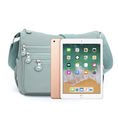Dark blue women's messenger shoulder bag by Jungle Line, large capacity with multiple compartments and adjustable strap.