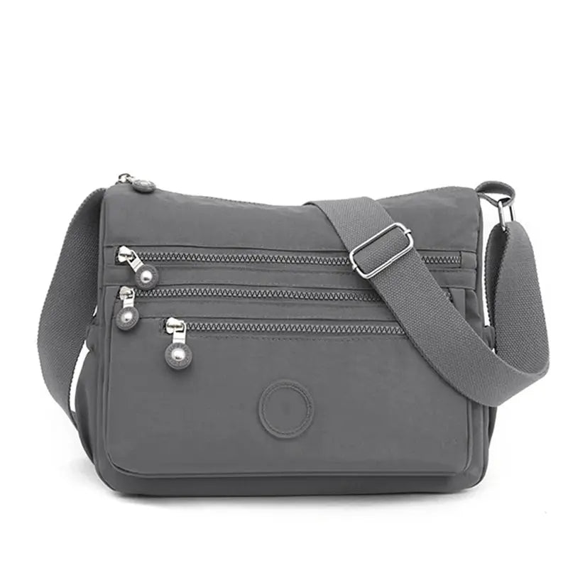 Dark blue women's messenger shoulder bag by Jungle Line with large capacity, featuring multiple compartments and adjustable strap.