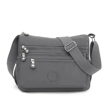 Dark blue women's messenger shoulder bag by Jungle Line with large capacity, featuring multiple compartments and adjustable strap.
