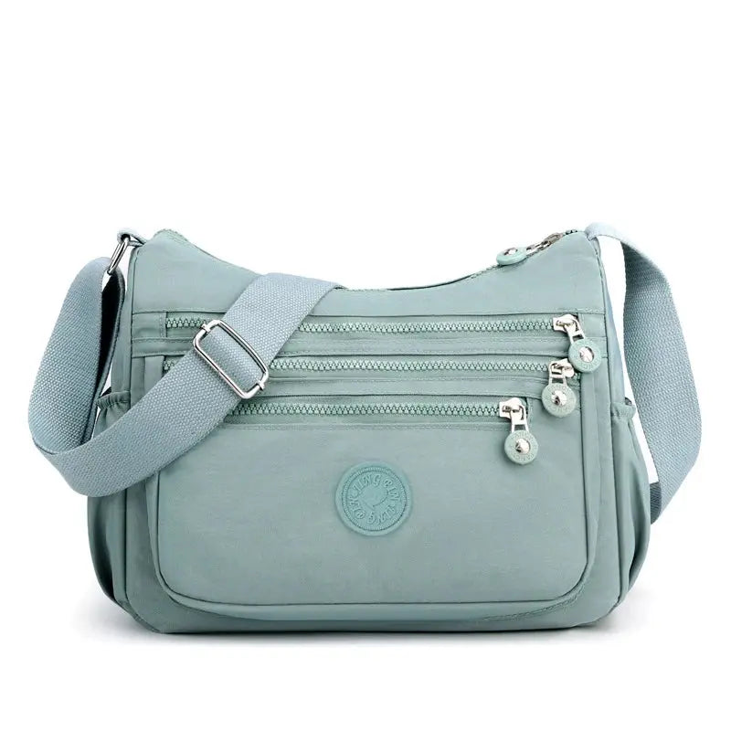 Dark blue Jungle Line women's messenger shoulder bag with large capacity, featuring multiple compartments and adjustable strap.