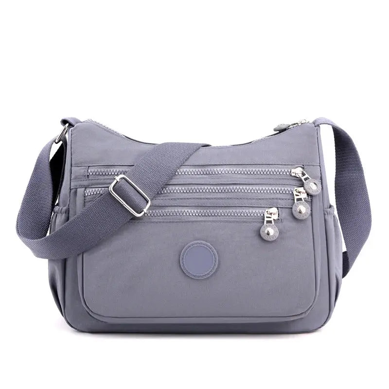 Dark blue Jungle Line women's messenger shoulder bag with large capacity, featuring adjustable strap and multiple compartments.