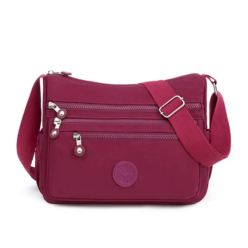 Dark blue women's messenger shoulder bag by Jungle Line, large capacity with multiple compartments and adjustable strap.