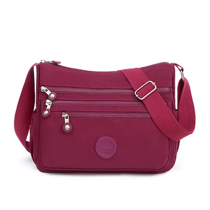 Dark blue women's messenger shoulder bag by Jungle Line, large capacity with multiple compartments and adjustable strap.