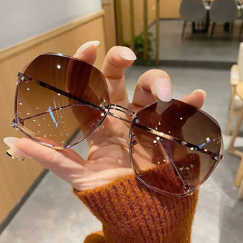 Polygonal metal sunglasses by Jungle Line with a modern design and grey frame, stylish for fashion-forward looks.