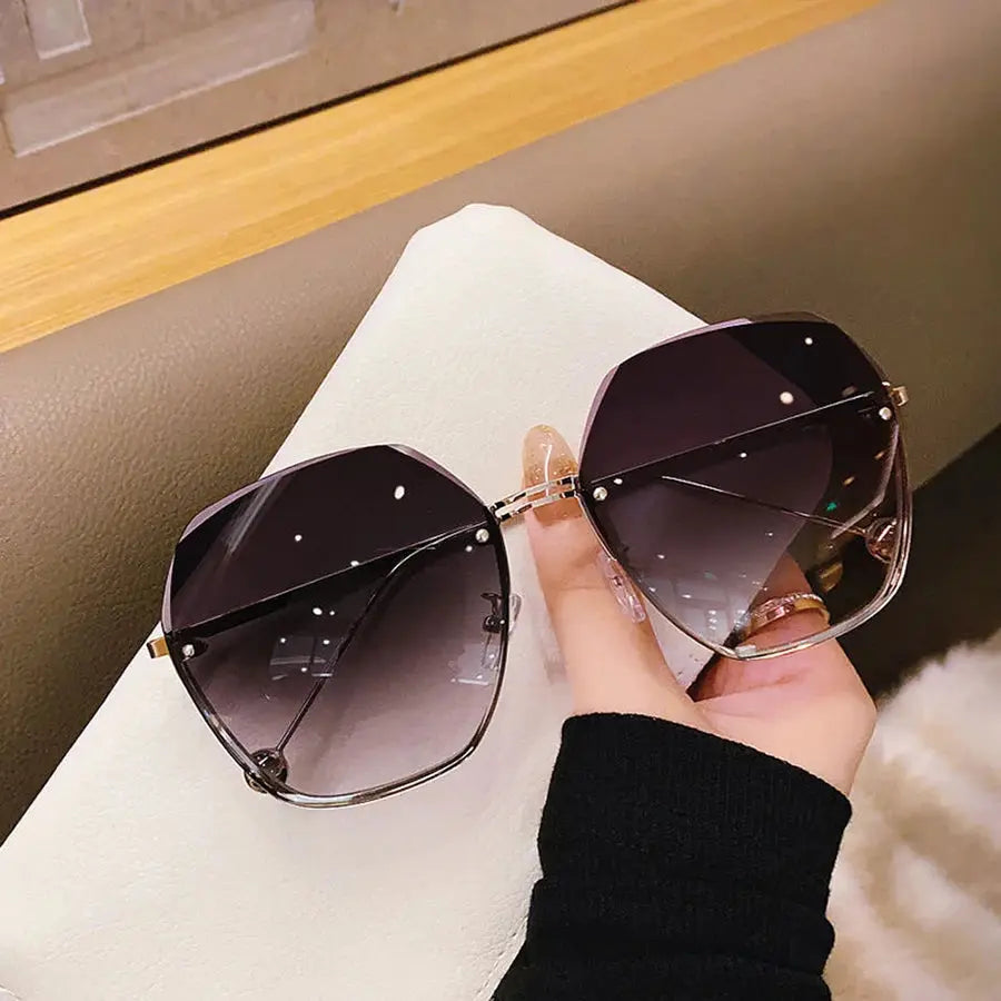 Polygonal metal sunglasses by Jungle Line featuring a modern brand design in a sleek grey finish.