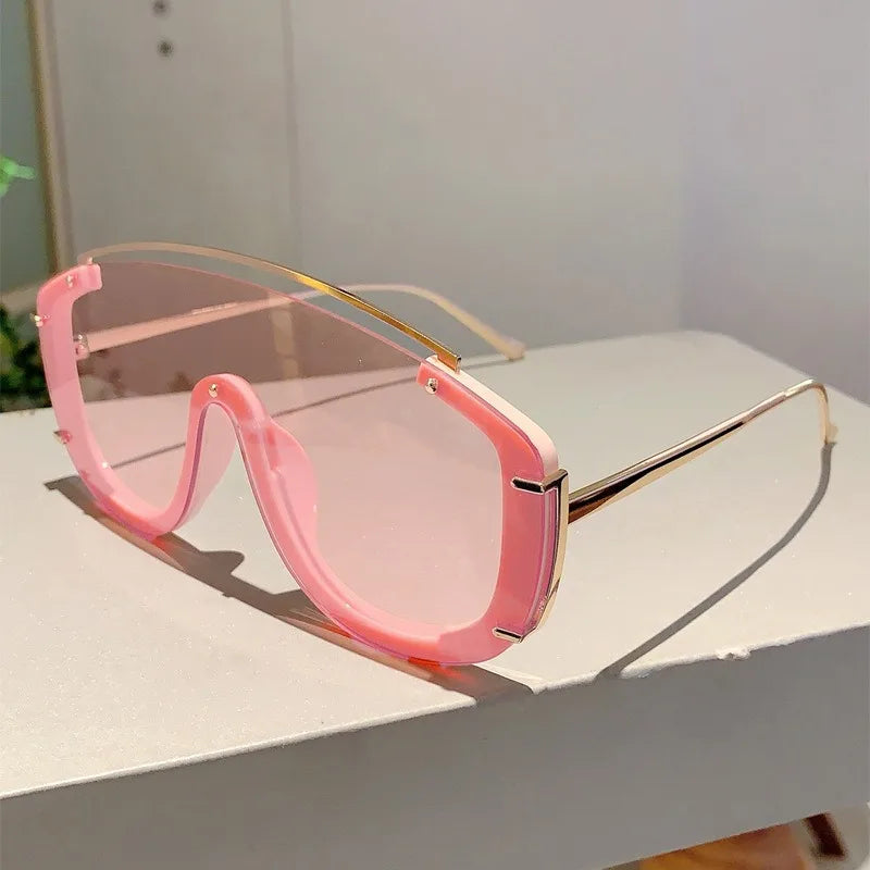 Lunettes de soleil oversize pour femmes et hommes de la marque Jungle Line, design métallique luxe avec motif léopard orange et dégradé.