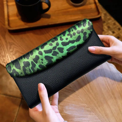 Long women's wallet by Jungle Line featuring a red leopard pattern and coin pocket, made of durable material.